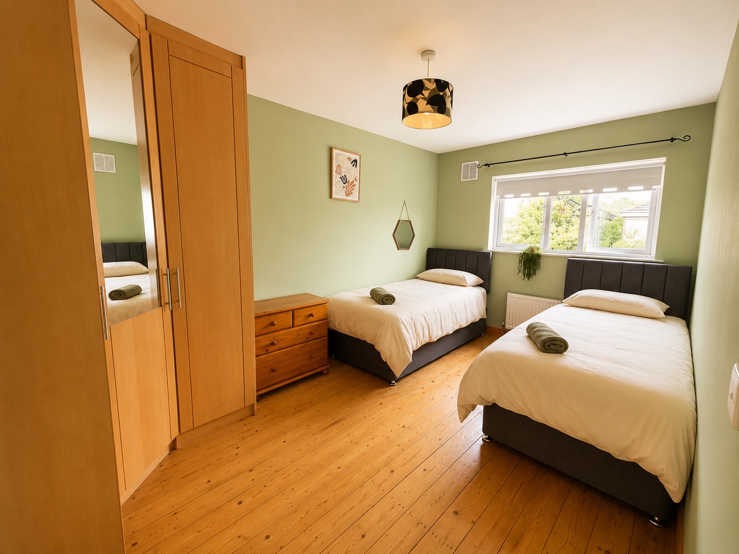Twin bedroom with sage green walls
